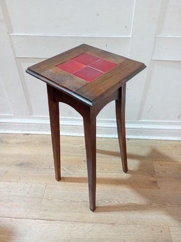 A tall Arts and Crafts dark oak jardiniere stand featuring four red ceramic tiles inset on the top surface and slim tapered legs. View VIII