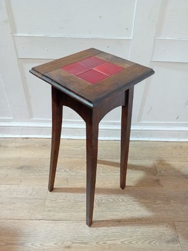 A tall Arts and Crafts dark oak jardiniere stand featuring four red ceramic tiles inset on the top surface and slim tapered legs. View XIV