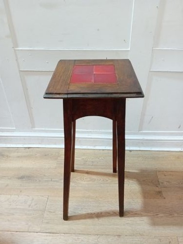 A tall Arts and Crafts dark oak jardiniere stand featuring four red ceramic tiles inset on the top surface and slim tapered legs. View XIII