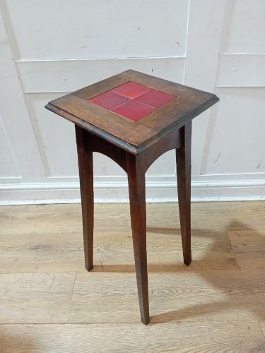 A tall Arts and Crafts dark oak jardiniere stand featuring four red ceramic tiles inset on the top surface and slim tapered legs. View XI
