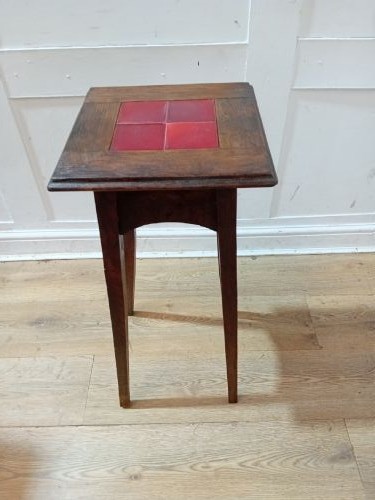 A tall Arts and Crafts dark oak jardiniere stand featuring four red ceramic tiles inset on the top surface and slim tapered legs. View XV
