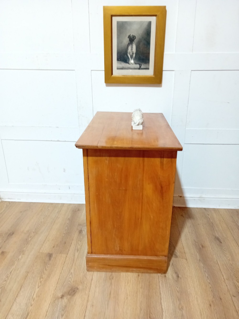 A late nineteenth-century satinwood chest of drawers with three full-width drawers and dark metal drop handles. View IX