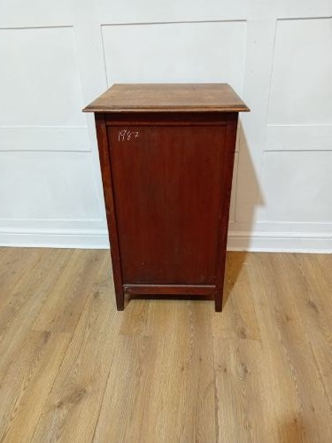 A warm brown Arts and Crafts oak hall cupboard with a two-panel door and a moulded flat top. View VII