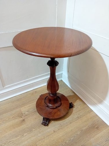A late Victorian circular mahogany side table featuring a smooth turned pedestal column and a shaped base. View VII