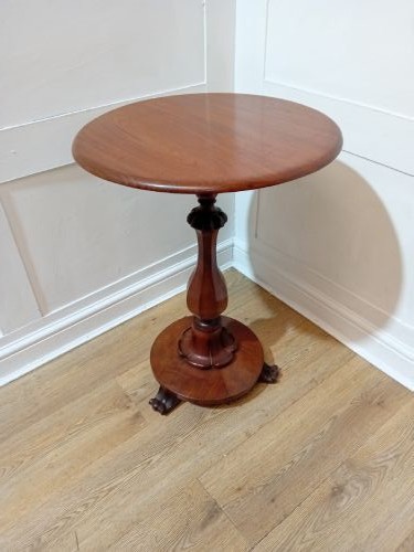 A late Victorian circular mahogany side table featuring a smooth turned pedestal column and a shaped base. View XII