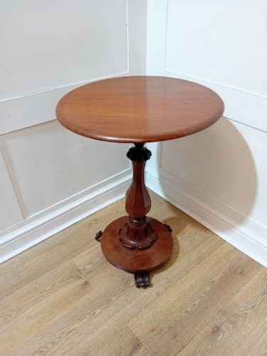 A late Victorian circular mahogany side table featuring a smooth turned pedestal column and a shaped base. View XI