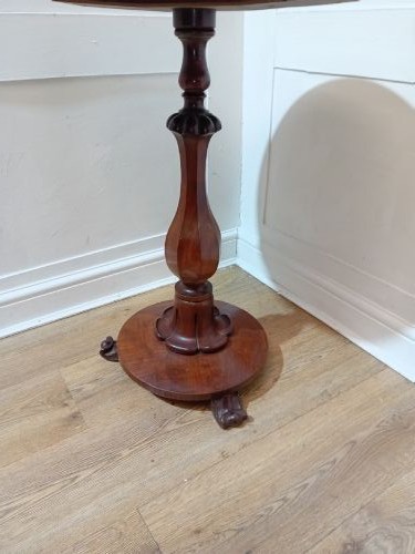 A late Victorian circular mahogany side table featuring a smooth turned pedestal column and a shaped base. View XV