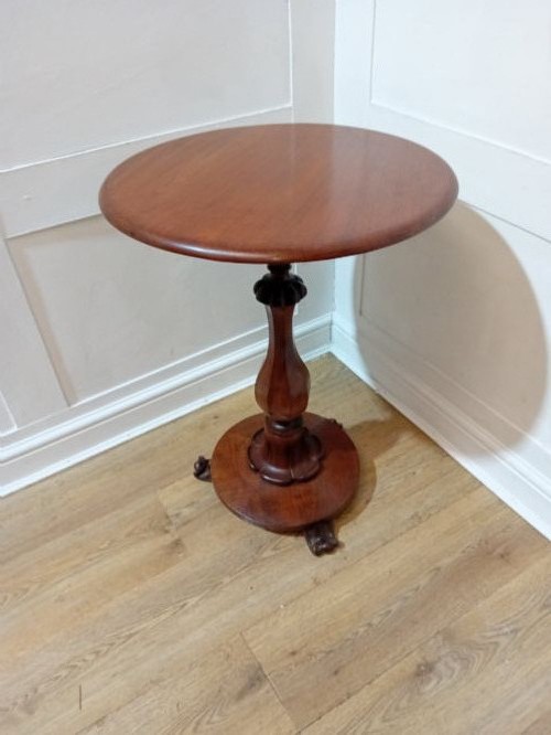 A late Victorian circular mahogany side table featuring a smooth turned pedestal column and a shaped base. View XIII