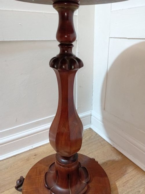 A late Victorian circular mahogany side table featuring a smooth turned pedestal column and a shaped base. View XIV