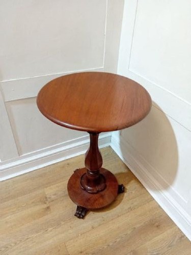 A late Victorian circular mahogany side table featuring a smooth turned pedestal column and a shaped base. View IX