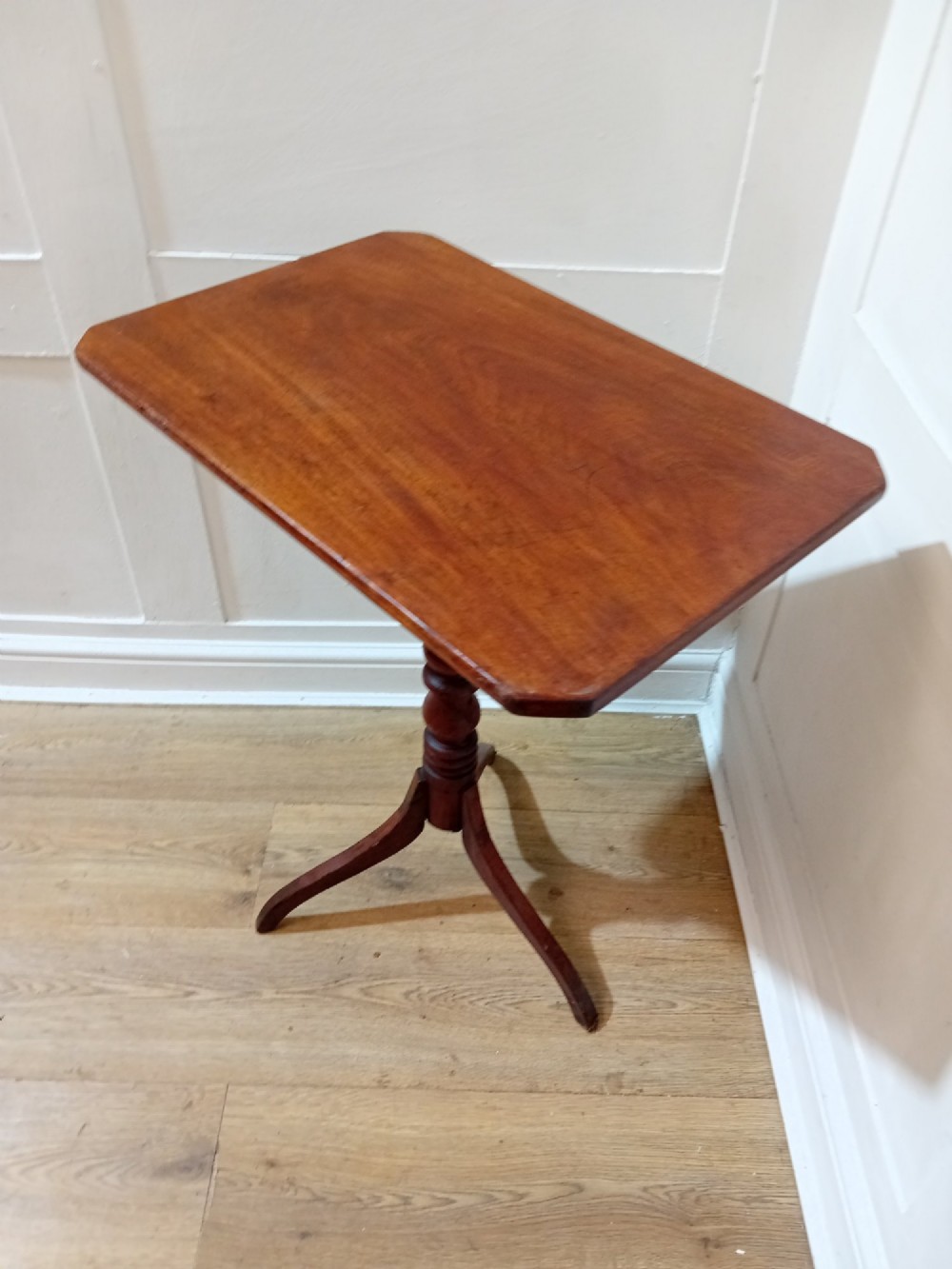 A Georgian oak wine table featuring a rectangular top with canted corners supported by a turned central pedestal and tripod base. View IX