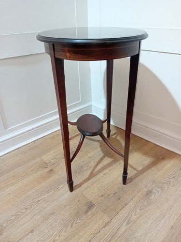 An antique oval dark mahogany occasional table featuring slender tapered legs connected by curved stretchers with a small central circular shelf. View V