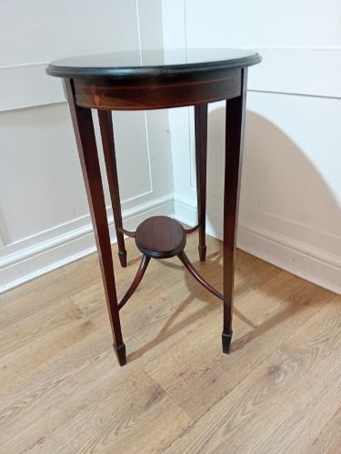 An antique oval dark mahogany occasional table featuring slender tapered legs connected by curved stretchers with a small central circular shelf. View VI
