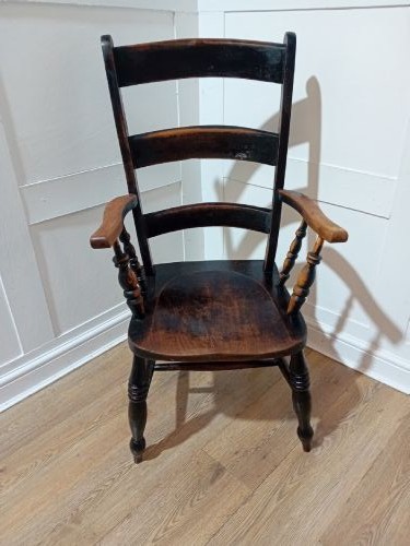 A Victorian Thames Valley Oxford wooden armchair featuring a three-slat ladder back, shaped wooden armrests, a contoured wooden seat, and turned legs with a dark patinated finish. View II