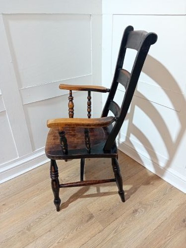 A Victorian Thames Valley Oxford wooden armchair featuring a three-slat ladder back, shaped wooden armrests, a contoured wooden seat, and turned legs with a dark patinated finish. View IV