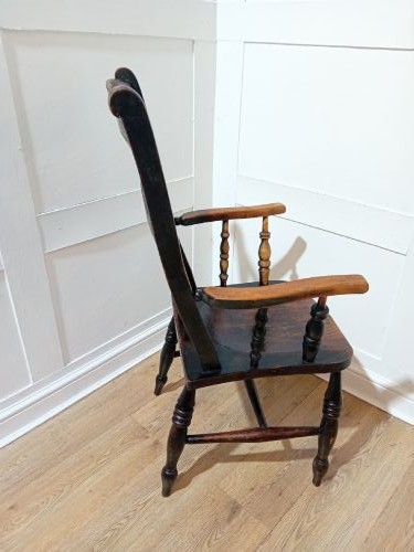 A Victorian Thames Valley Oxford wooden armchair featuring a three-slat ladder back, shaped wooden armrests, a contoured wooden seat, and turned legs with a dark patinated finish. View VI