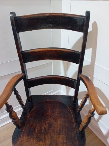 A Victorian Thames Valley Oxford wooden armchair featuring a three-slat ladder back, shaped wooden armrests, a contoured wooden seat, and turned legs with a dark patinated finish. View IX