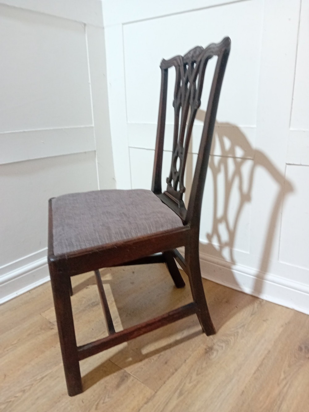 An 18th-century George III mahogany side chair featuring a carved pierced splat back, upholstered drop-in seat, and straight square legs with H-stretcher support. View VIII