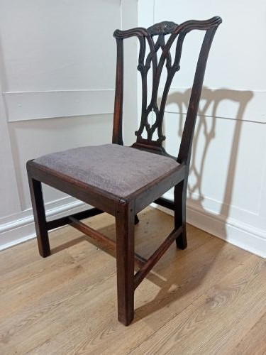 An 18th-century George III mahogany side chair featuring a carved pierced splat back, upholstered drop-in seat, and straight square legs with H-stretcher support. View VI