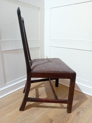 An 18th-century George III mahogany side chair featuring a carved pierced splat back, upholstered drop-in seat, and straight square legs with H-stretcher support. View X