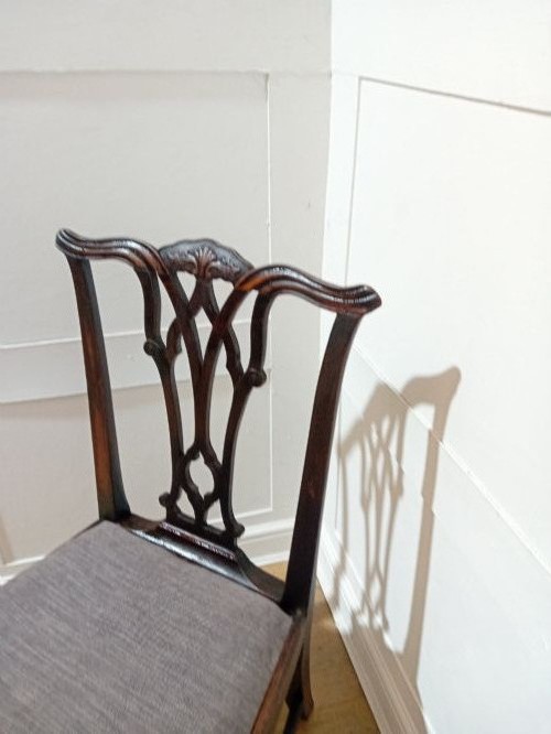 An 18th-century George III mahogany side chair featuring a carved pierced splat back, upholstered drop-in seat, and straight square legs with H-stretcher support. View XII