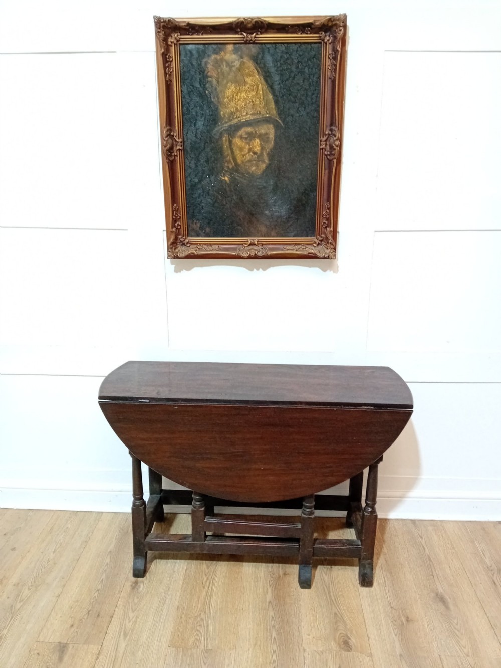 A seventeenth-century dark oak gateleg table with folded leaves, turned legs, and a stretcher base. View IV