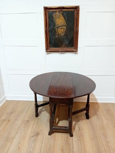 A seventeenth-century dark oak gateleg table with folded leaves, turned legs, and a stretcher base. View X