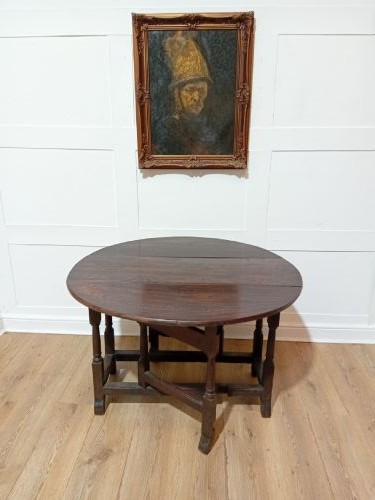 A seventeenth-century dark oak gateleg table with folded leaves, turned legs, and a stretcher base. View XIV