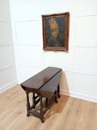 A seventeenth-century dark oak gateleg table with folded leaves, turned legs, and a stretcher base. View VI