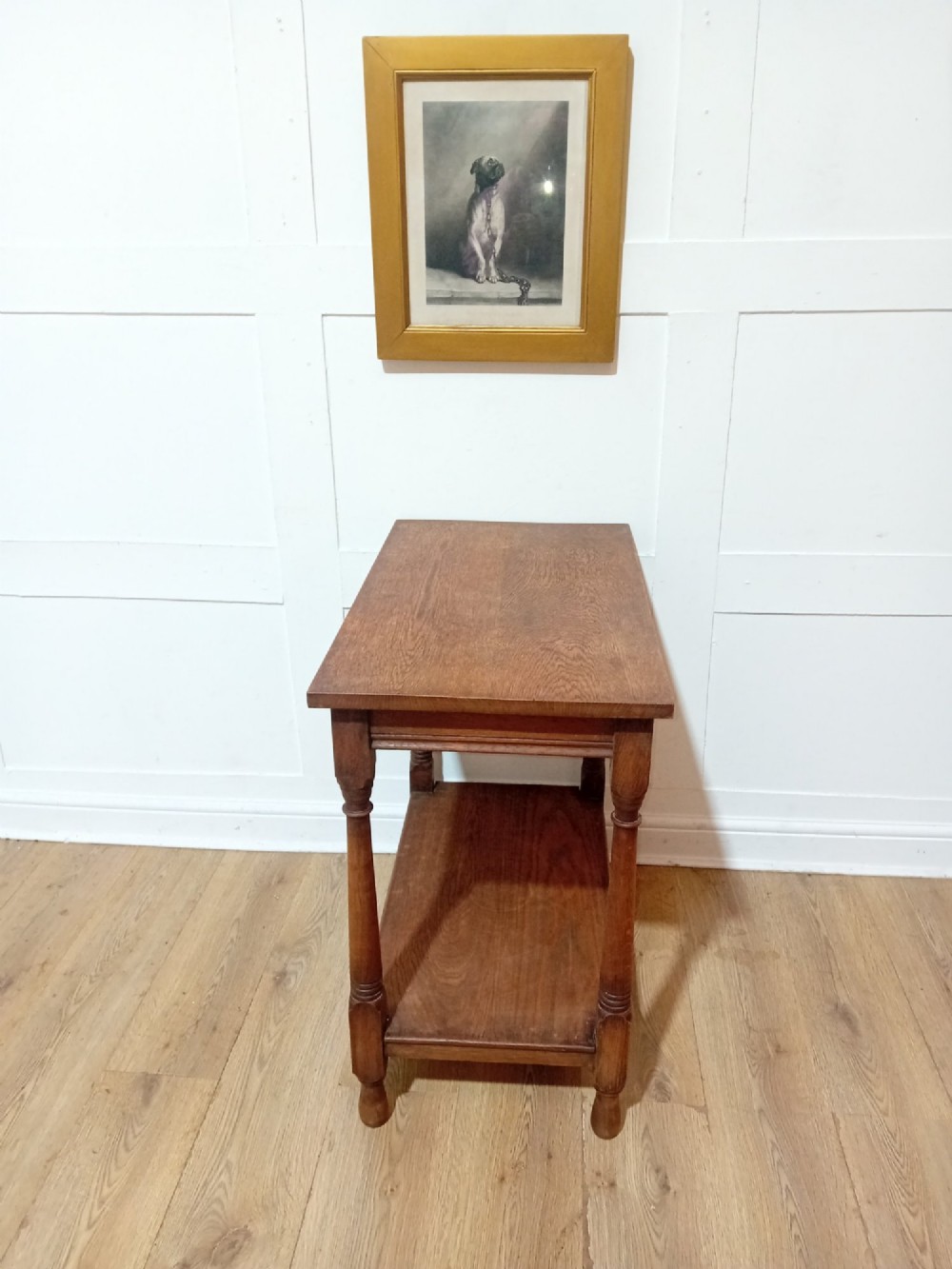 A late Victorian medium brown oak side table featuring a rectangular top, an open lower shelf, and four slender turned wooden legs. View VII