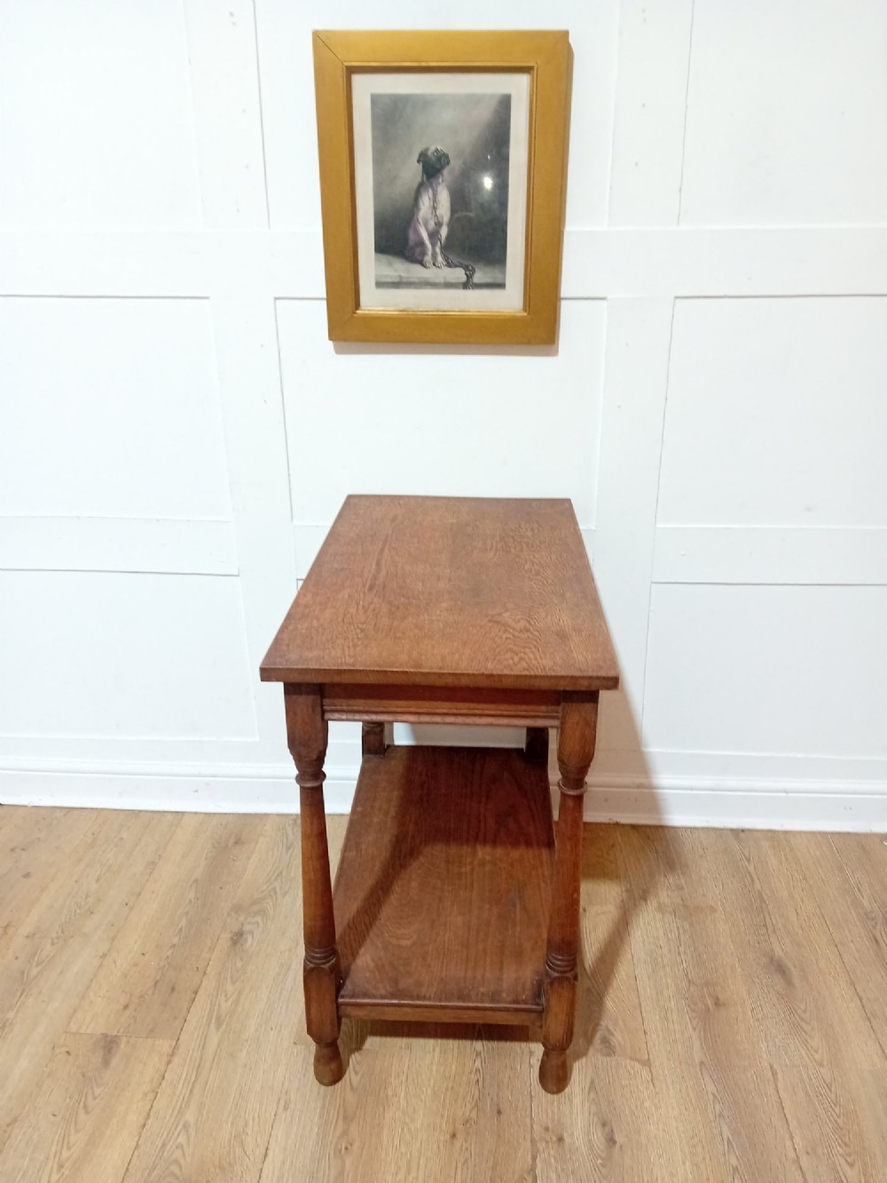 A late Victorian medium brown oak side table featuring a rectangular top, an open lower shelf, and four slender turned wooden legs. View VIII