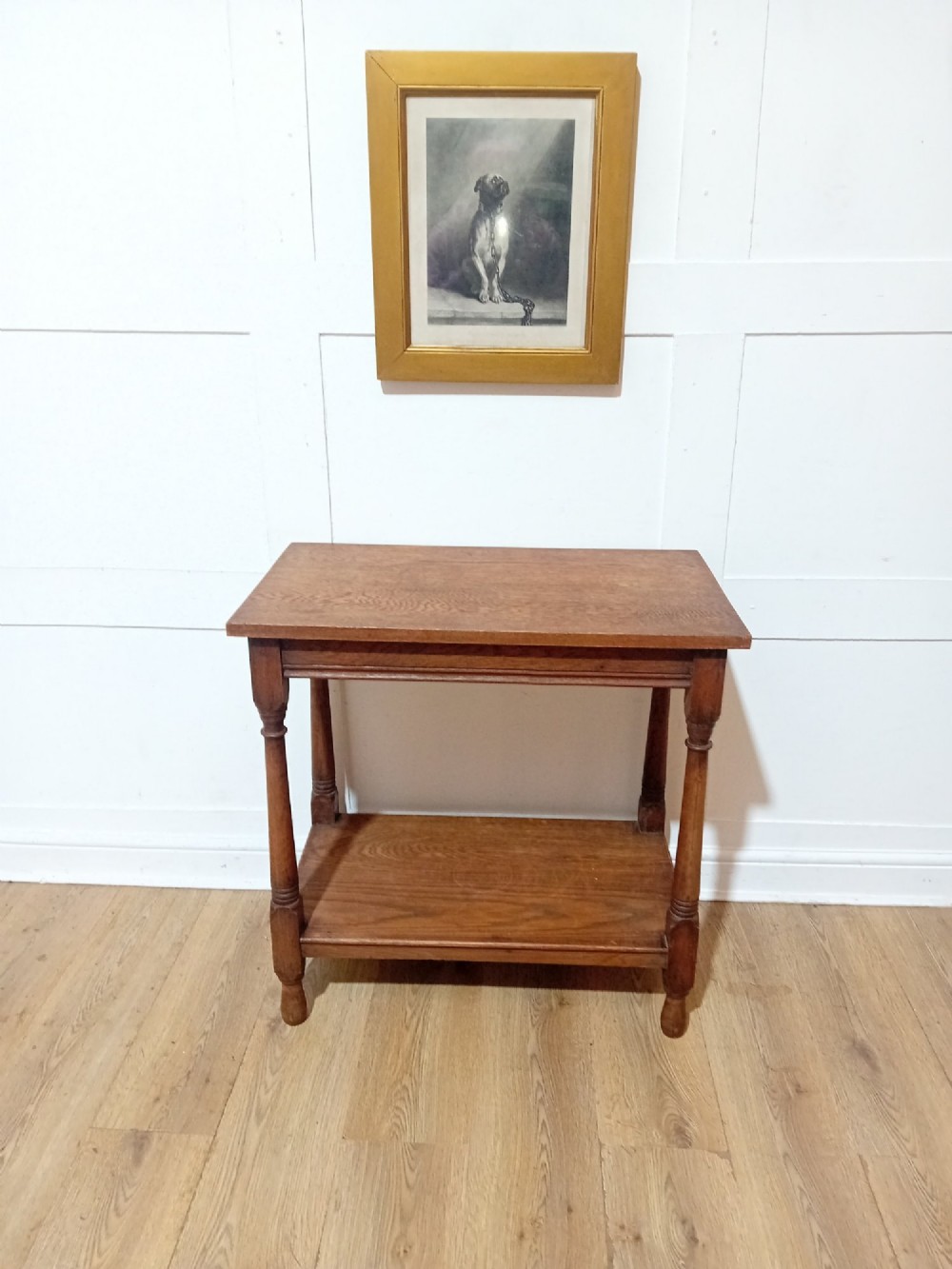 A late Victorian medium brown oak side table featuring a rectangular top, an open lower shelf, and four slender turned wooden legs. View IX