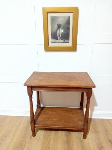 A late Victorian medium brown oak side table featuring a rectangular top, an open lower shelf, and four slender turned wooden legs. View III