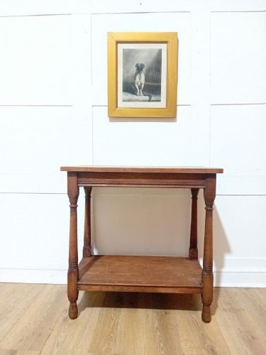 A late Victorian medium brown oak side table featuring a rectangular top, an open lower shelf, and four slender turned wooden legs. View IV