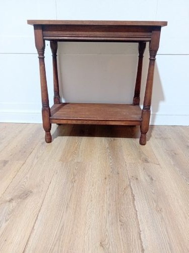 A late Victorian medium brown oak side table featuring a rectangular top, an open lower shelf, and four slender turned wooden legs. View V