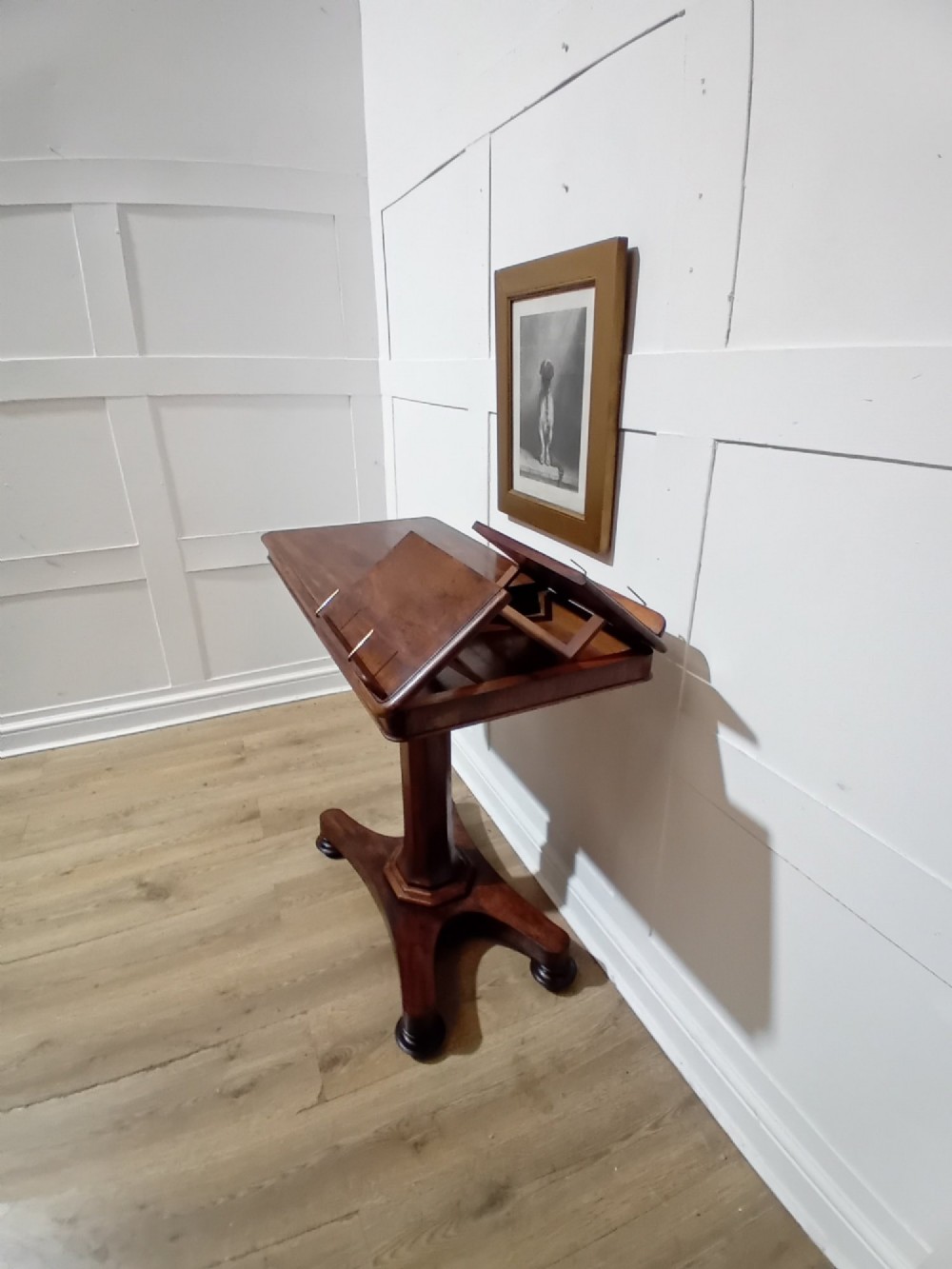 An antique Victorian mahogany reading table featuring a dual tilting ratcheted top on a turned pedestal column and quadripartite base. View VIII
