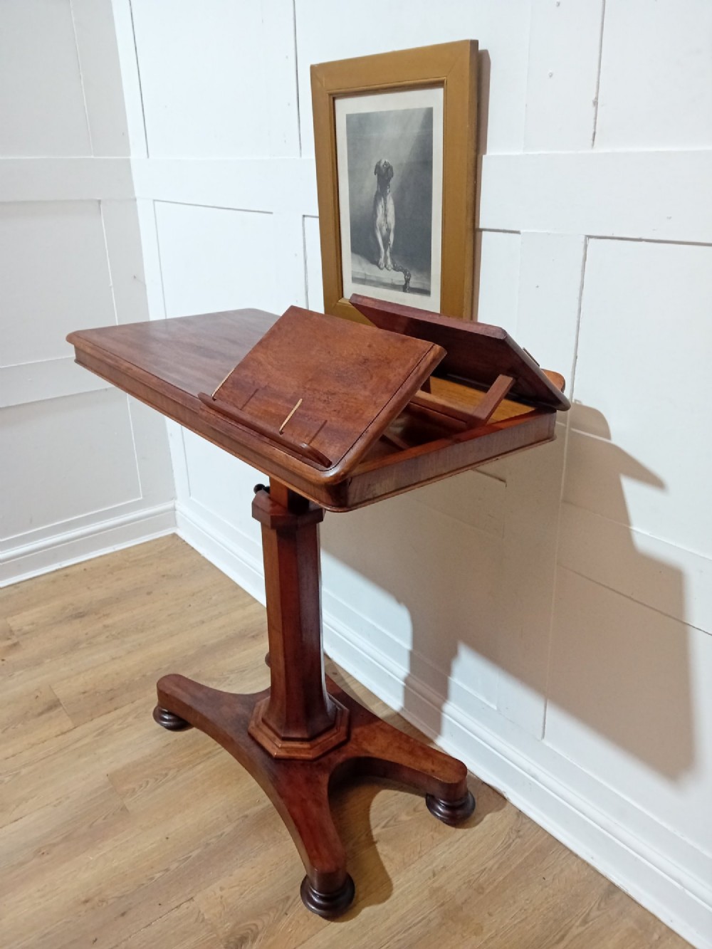 An antique Victorian mahogany reading table featuring a dual tilting ratcheted top on a turned pedestal column and quadripartite base. View X