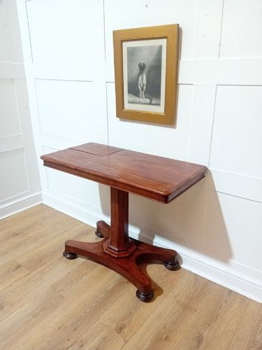 An antique Victorian mahogany reading table featuring a dual tilting ratcheted top on a turned pedestal column and quadripartite base. View II