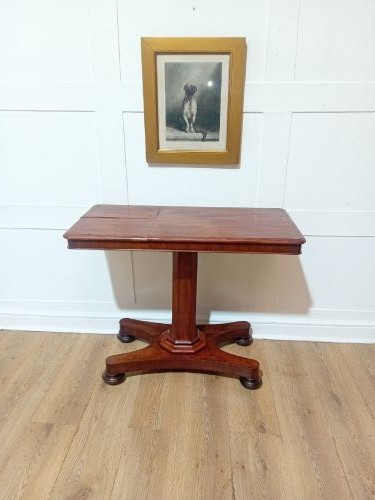 An antique Victorian mahogany reading table featuring a dual tilting ratcheted top on a turned pedestal column and quadripartite base. View IV