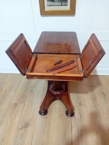 An antique Victorian mahogany reading table featuring a dual tilting ratcheted top on a turned pedestal column and quadripartite base. View VI