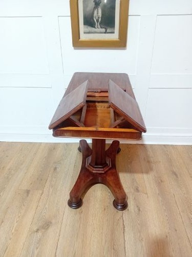 An antique Victorian mahogany reading table featuring a dual tilting ratcheted top on a turned pedestal column and quadripartite base. View VII