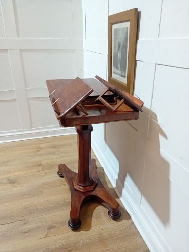 An antique Victorian mahogany reading table featuring a dual tilting ratcheted top on a turned pedestal column and quadripartite base. View XI
