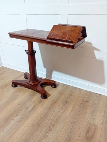 An antique Victorian mahogany reading table featuring a dual tilting ratcheted top on a turned pedestal column and quadripartite base. View XV