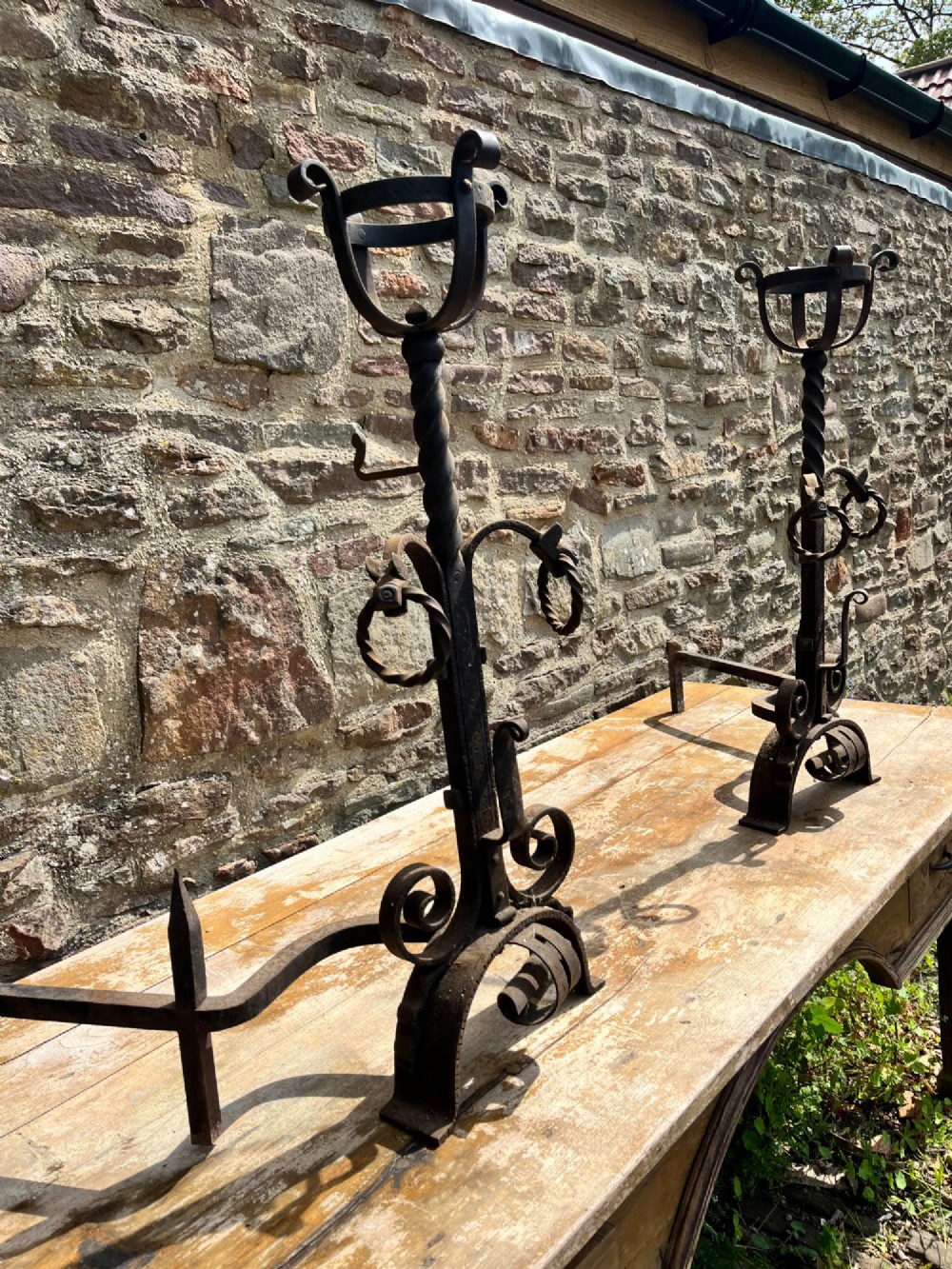 Pair of antique hand-forged wrought iron firedogs featuring barley twist stems, cresset basket tops, scrolled feet, and rear log rests. View VI