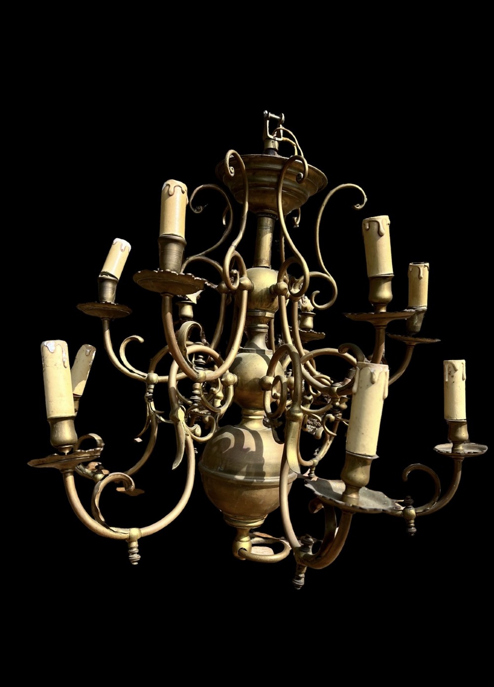 An antique brass gasolier chandelier featuring multiple scrolled arms, faux candle light sockets, and a central bulbous stem.