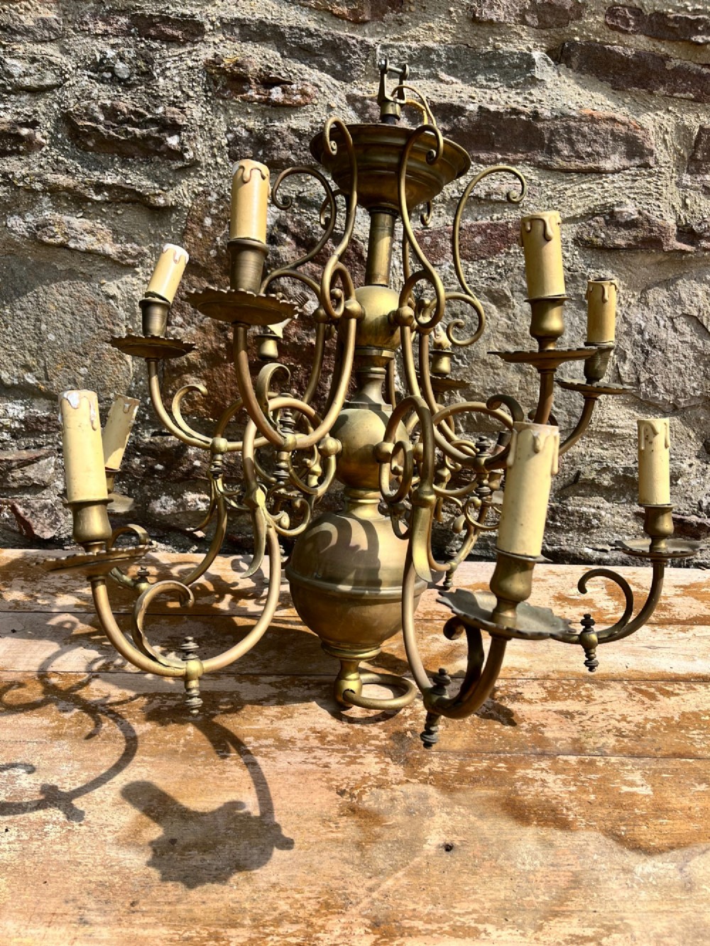 An antique brass gasolier chandelier featuring multiple scrolled arms, faux candle light sockets, and a central bulbous stem. View III