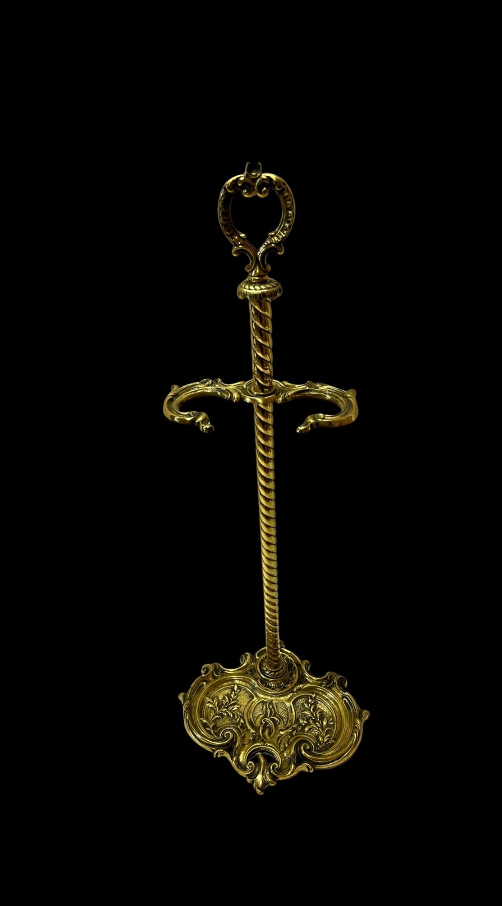 An ornate brass fire iron tidy featuring a detailed scrollwork base, a twisted central column, dual hanging hooks, and an ornamental top handle.