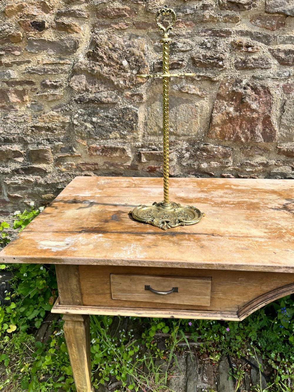 An ornate brass fire iron tidy featuring a detailed scrollwork base, a twisted central column, dual hanging hooks, and an ornamental top handle. View III