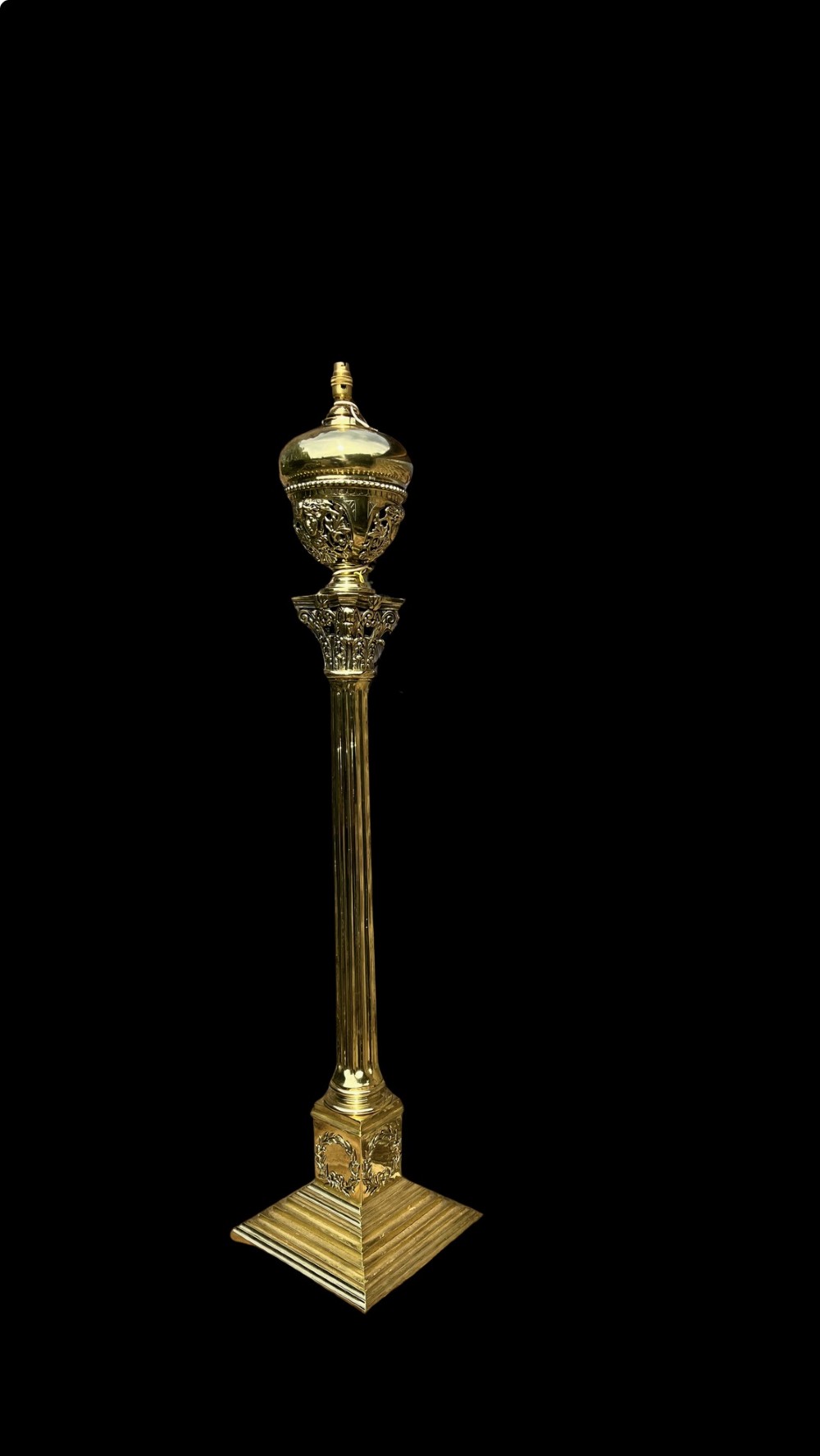 An antique polished brass standard floor lamp featuring a fluted column, classical Corinthian capital, urn motif, and stepped square base. View II