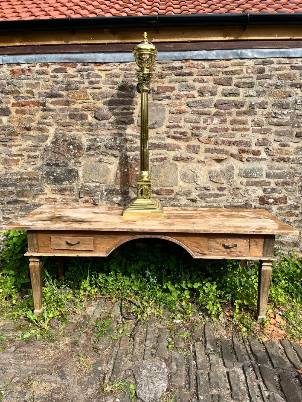 An antique polished brass standard floor lamp featuring a fluted column, classical Corinthian capital, urn motif, and stepped square base. View VI